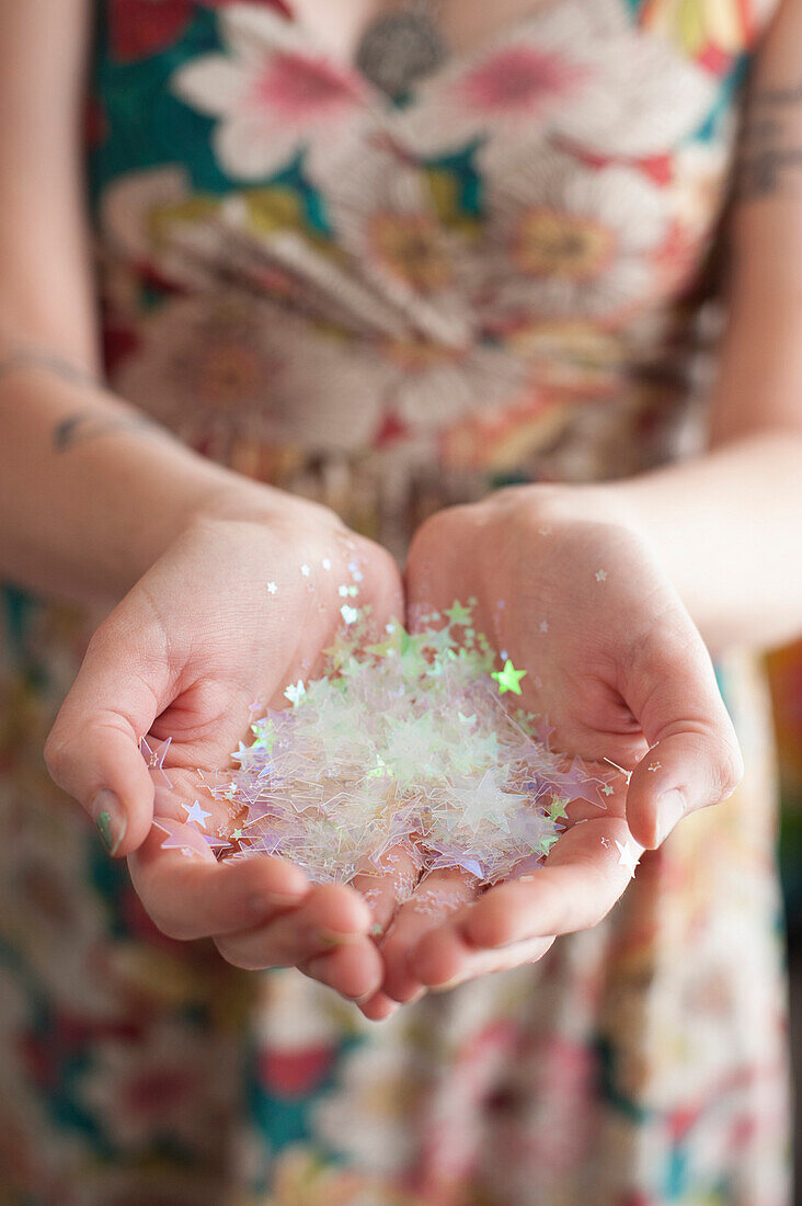 Hands Holding Clear Star Confetti