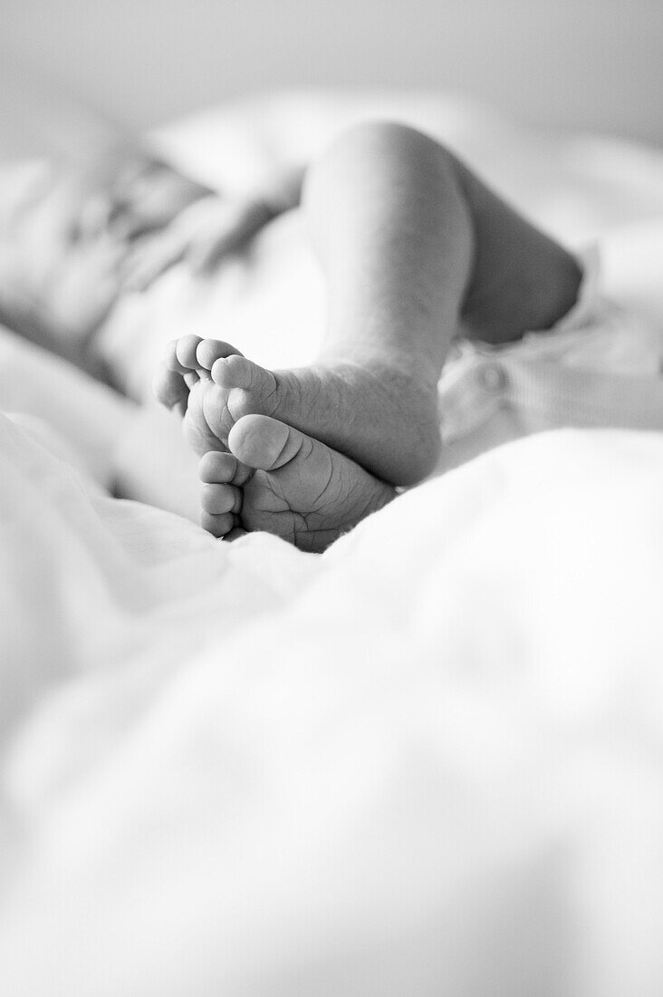 Newborn Baby's Feet on Bed