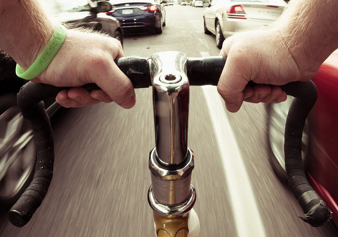 Bicycle Rider in Traffic, Close Up of Hands on Handlebar