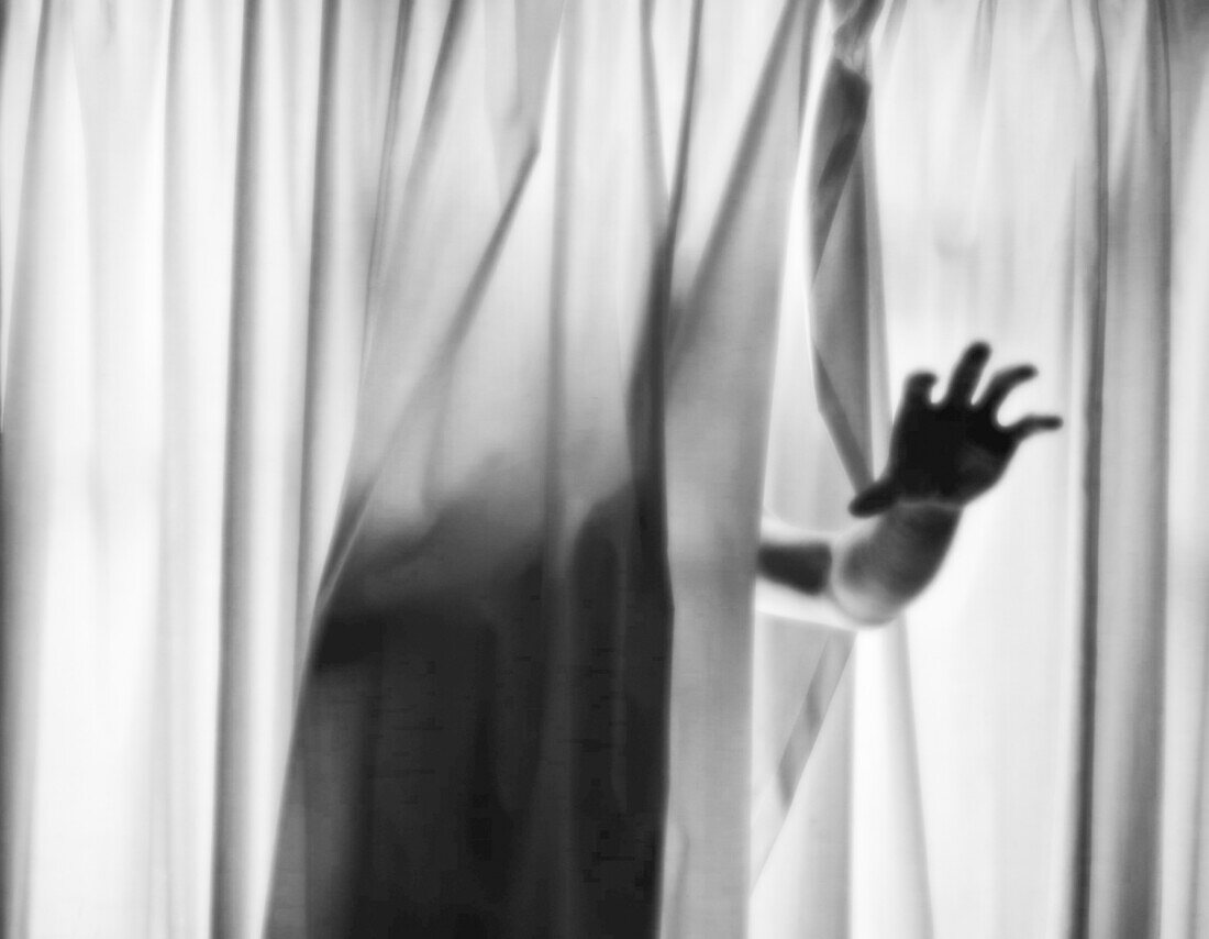 Hand Reaching out from Curtains