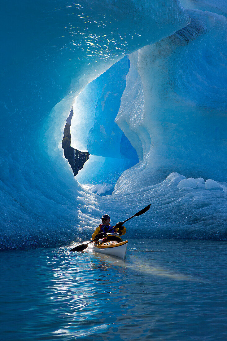 Sea Kayaker On Mendenhall Lake With Big Blue Iceberg In The Background, Southeast Alaska, Summer