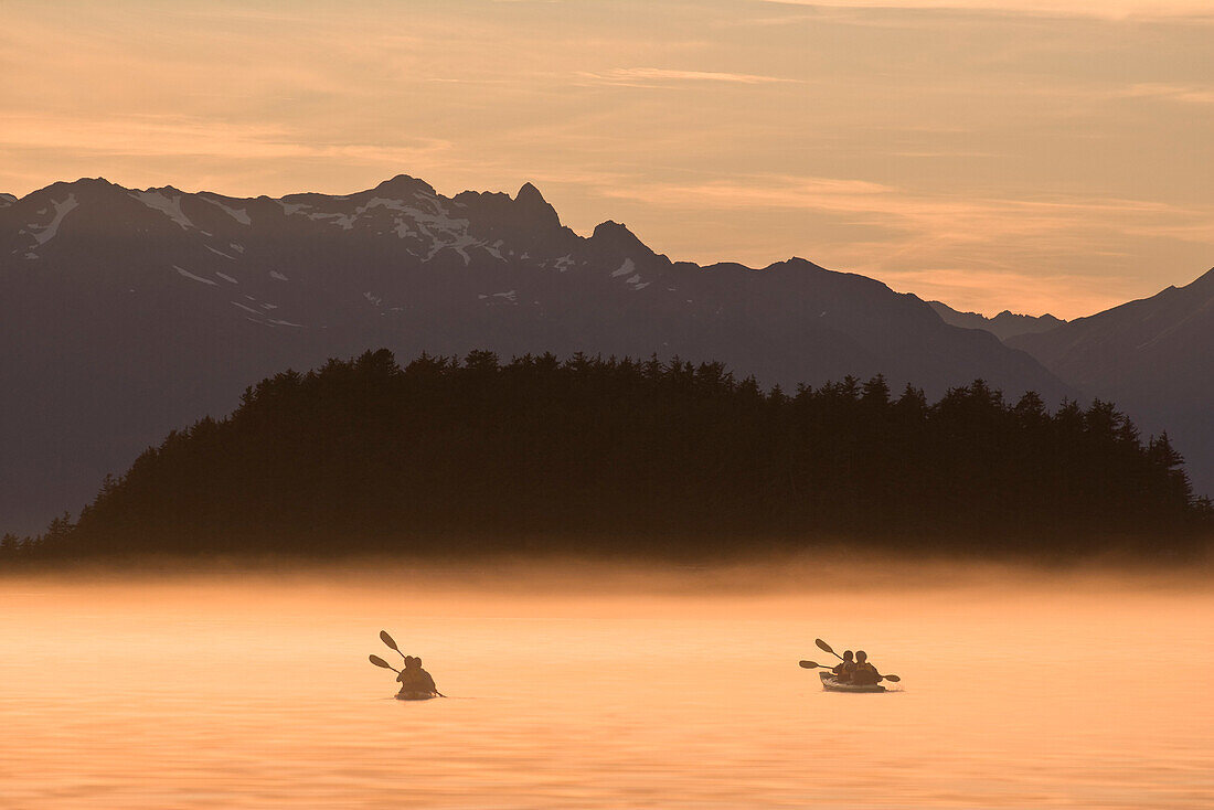 Kayakers Paddling Through The Misty Waters Of Favorite Passage, Near Sentinel Island. Summer In Southeast Alaska.