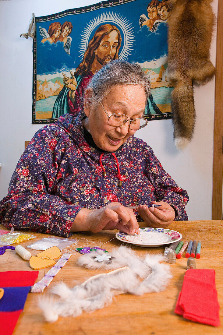 Native Female Yupik Elder Sitting @ Kitchen Table Doing Beadwork Akiachak Western Alaska Indoors