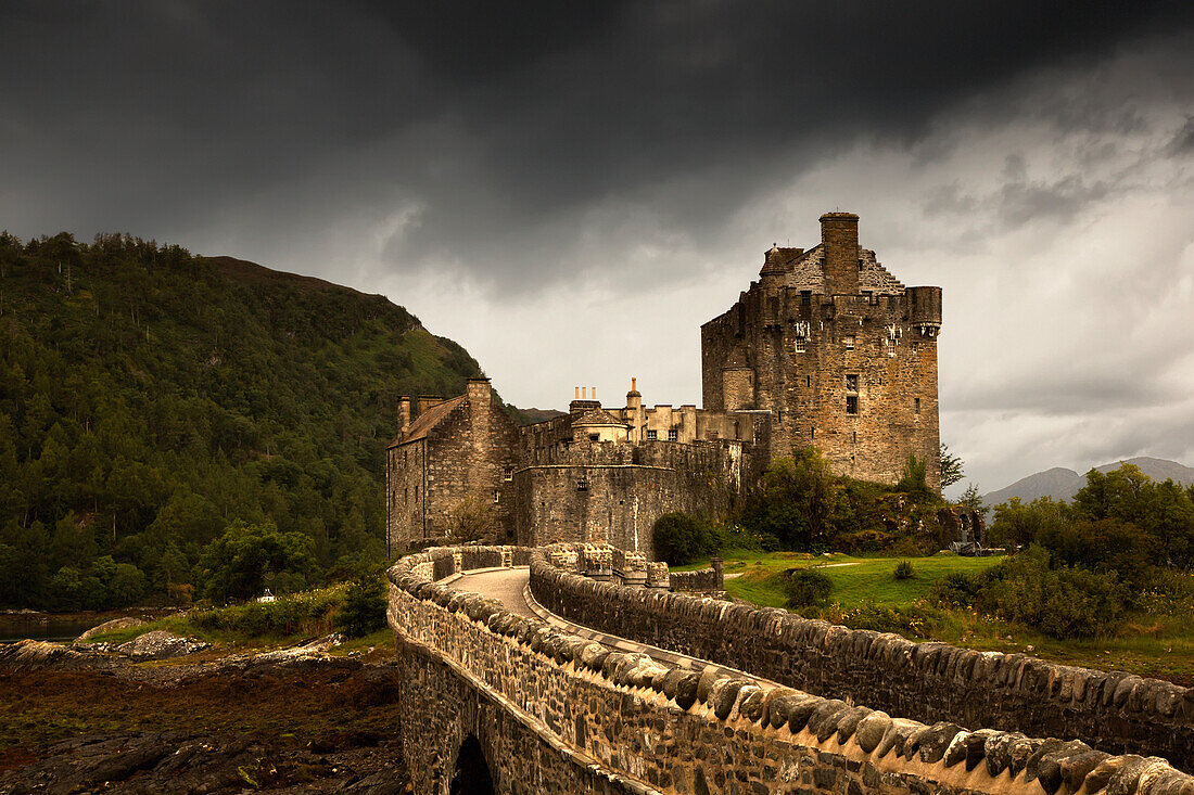 'Stone Bridge Leading To A Castle Under A Stormy Sky; Kyle Of Lochalsh Highlands Scotland'