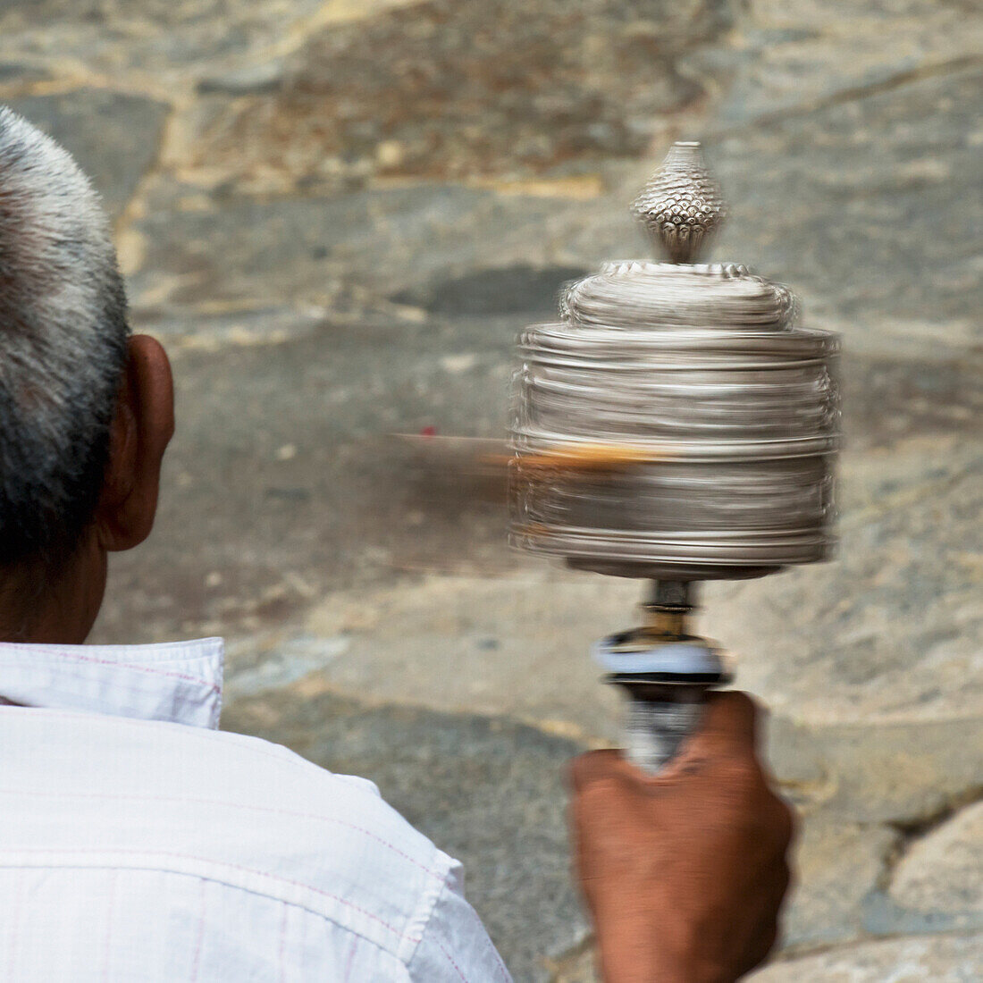 'China, Xizang, Man Holding Prayer Wheel; Tibet'