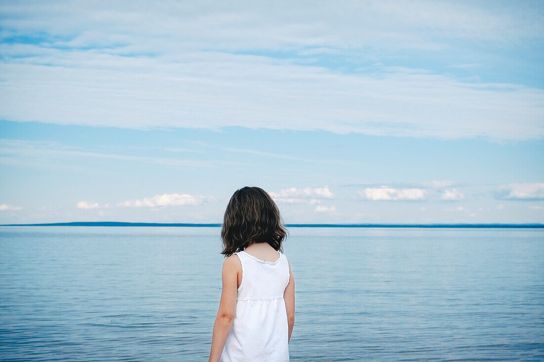 'Young Girl In White Top Facing A River;Saint-Simeon Quebec Canada'