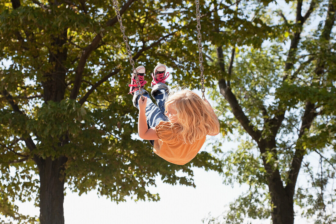 'Young Girl Swinging High In The Air;Ontario Canada'