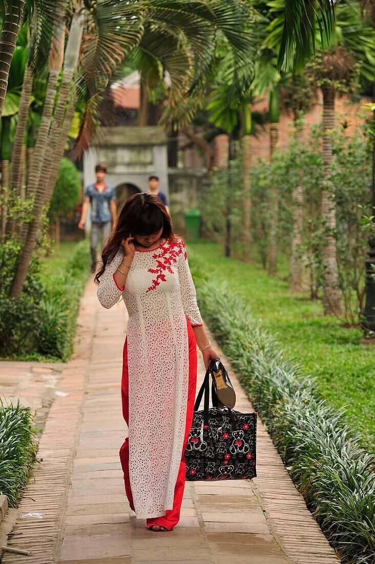 Vietnamese graduate wearing tradional dress Ao Dai at Temple of Literature, Hanoi, Vietnam