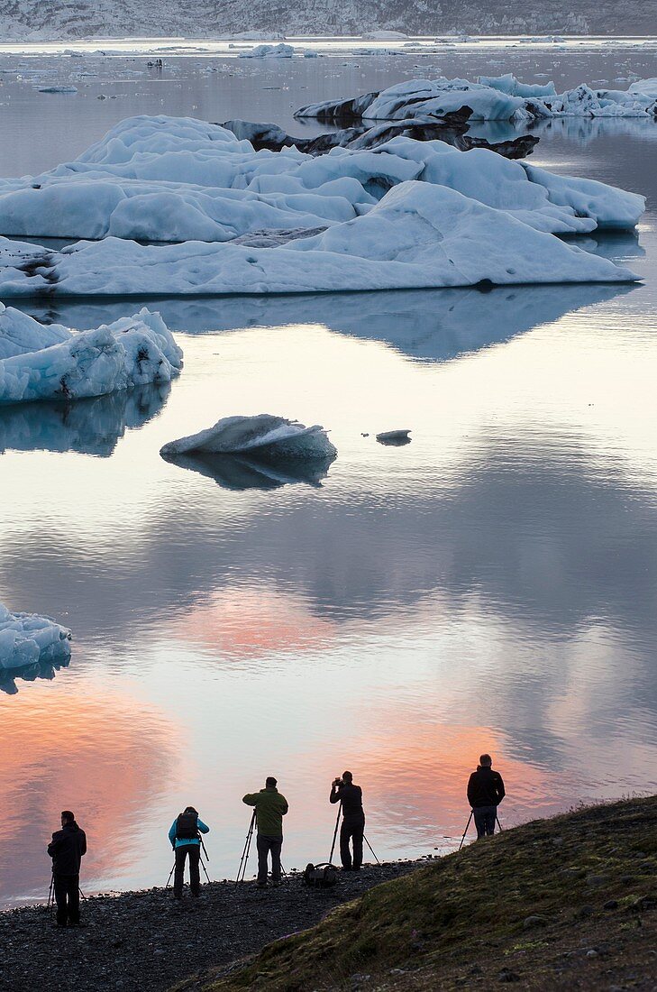 Photographers silhouette in Jökulsarlón glacial lagoon  Iceland