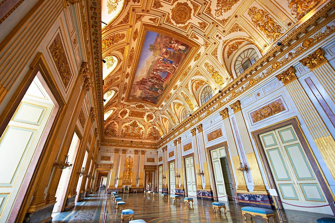 The Throne Room is nearly 40 meters long and was completed in 1845  On the back wall is placed a portable guilder throne  The decorations symbolise absolute power  The architrave in the room is decorated with portraits of the sovereigns of Naples stating 