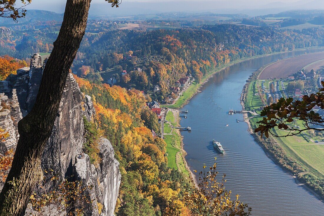 View from the spectacular rock formation Bastei (Bastion) to health resort Rathen and the Elbe River. The Bastei is one of the most visited tourist attractions in the national park Saxon Switzerland, municipality Lohmen, near Dresden, Saxony, Germany, Eur