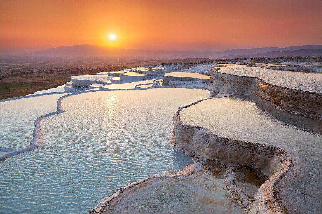 Pamukkale, Turkey - the limestone terraces left by the flowing water, view at sunset time Pamukkale near Denizli