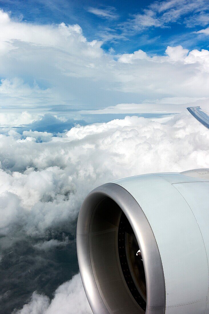 An aircraft engine and clouds out an airplane window