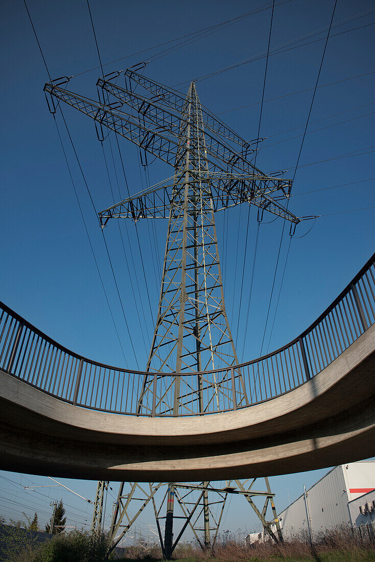 Electricity Pylon and power cable behind a bike track near a bridge, New-Ulm, Bavaria, Germany