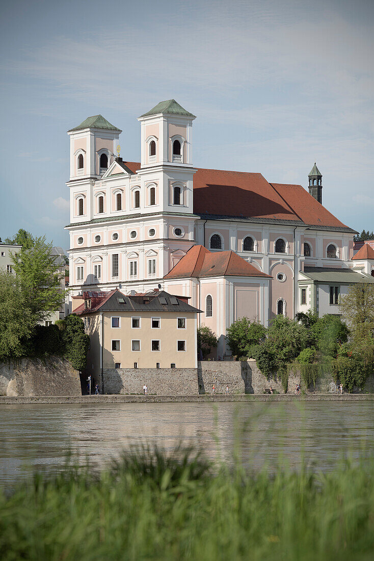 view of St. Michael's church with Inn river in the foreground, old town of Passau, Bavaria, Germany
