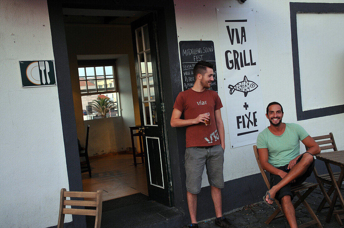 Two men sitting outside a bar in Madalena, Island of Pico, Azores, Portugal