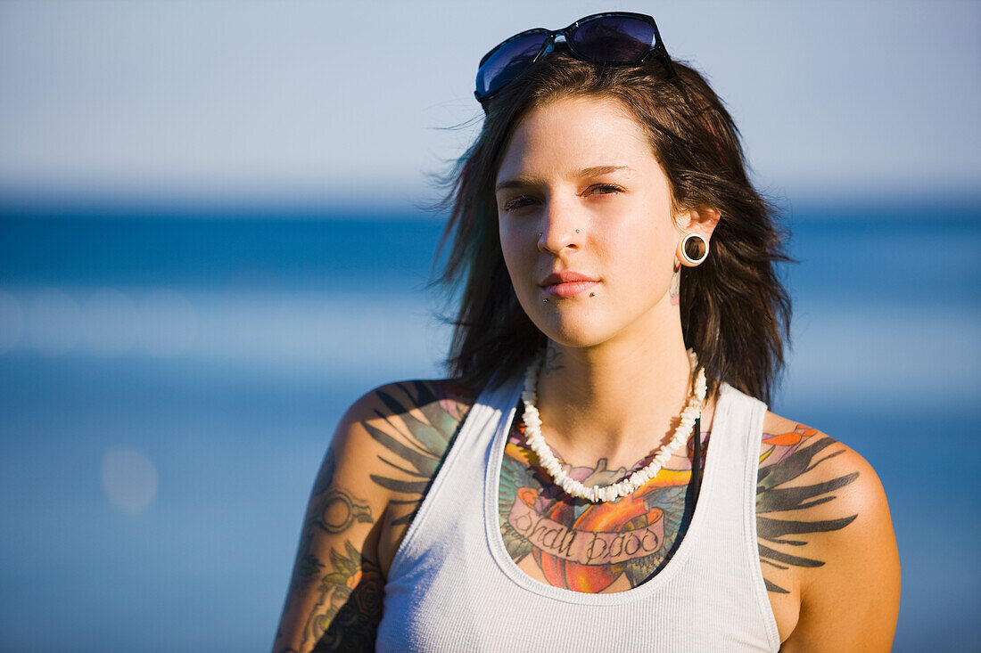 Young Woman With Tattoos Sitting By Lake Simcoe, Ontario Canada