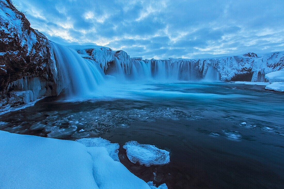 Godafoss with large pieces of ice forming in the cold weather, Iceland