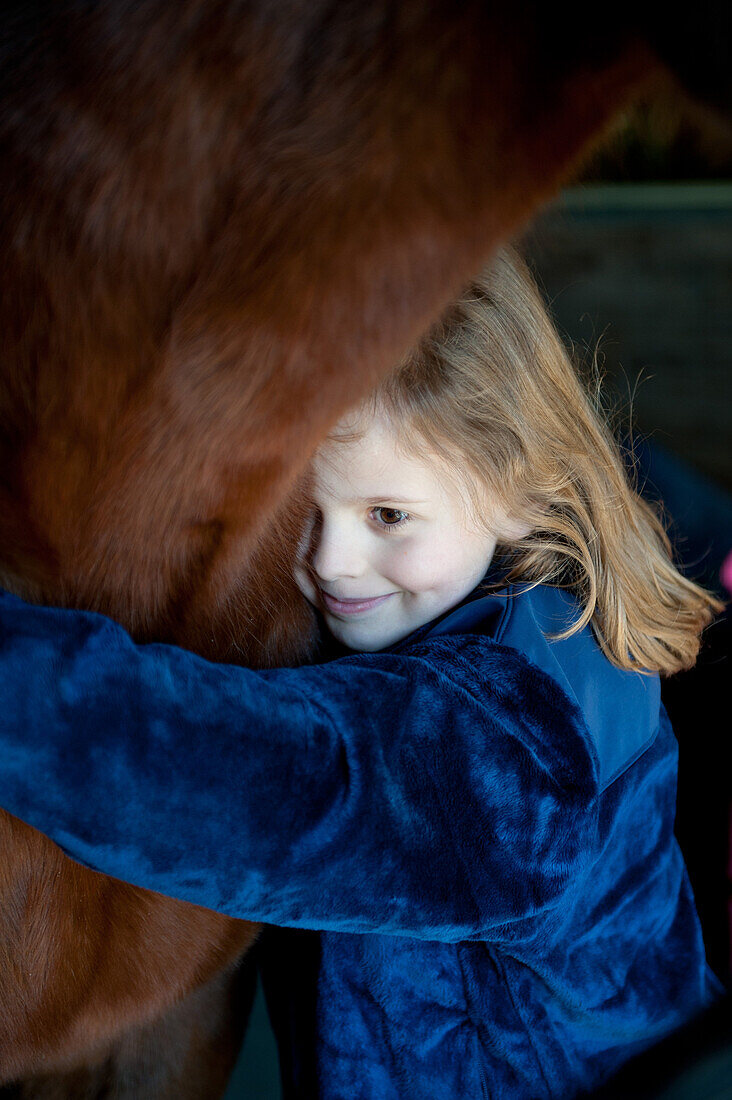Young Girl Embracing Horse