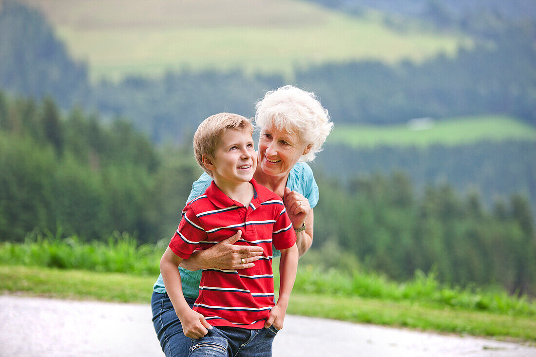 Grandmother embracing grandson (7 years), Styria, Austria