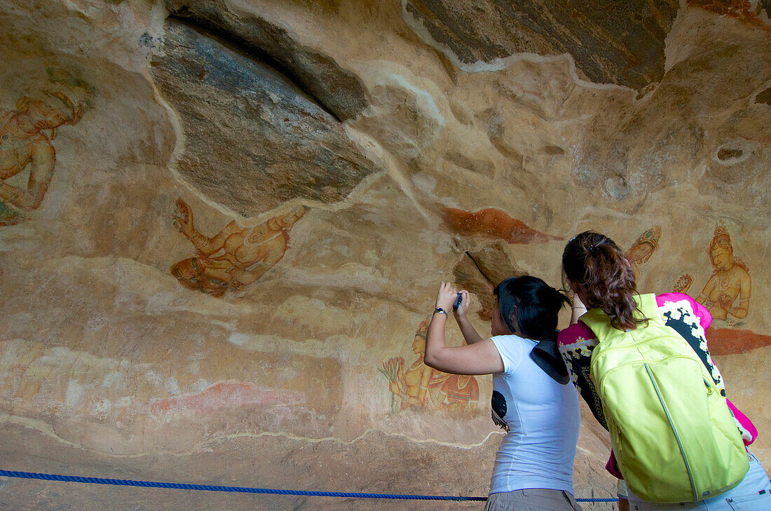 Asian tourists taking pictures of the Sigiriya Mamsells, frescoes on the rock, Sigiriya, Matale Distict, Cultural Triangel, Sri Lanka