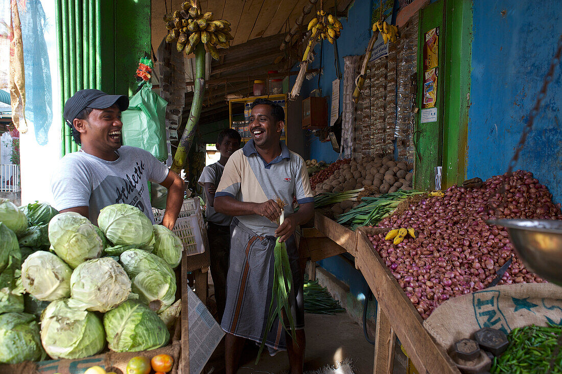 Laughing Sri Lankan vendors at a vegtable stall in Valaichchenai, next to Passekudah, Eastern Sri Lanka, South Asia
