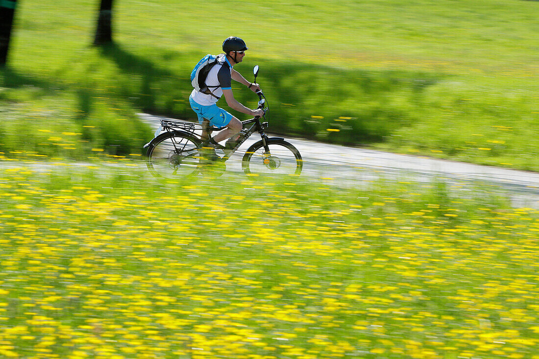 Pedelec cyclist on the way, Upper Bavaria, Germany