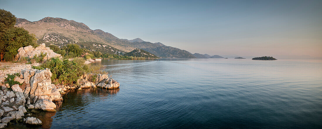 Rocky coastline with view of the surrounding mountains and islands in the lake, Murici, Lake Skadar National Park, Montenegro, Western Balkan, Europe