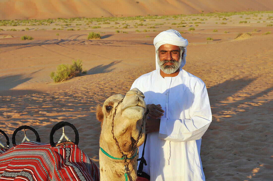 Camel and guide in Liwa desert, Abu Dahbi, United Arab Emirates