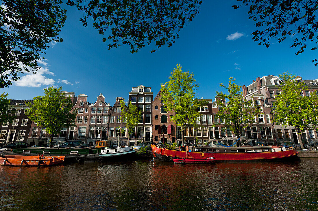 Dutch barges on canal and gabled houses, Amsterdam, Holland