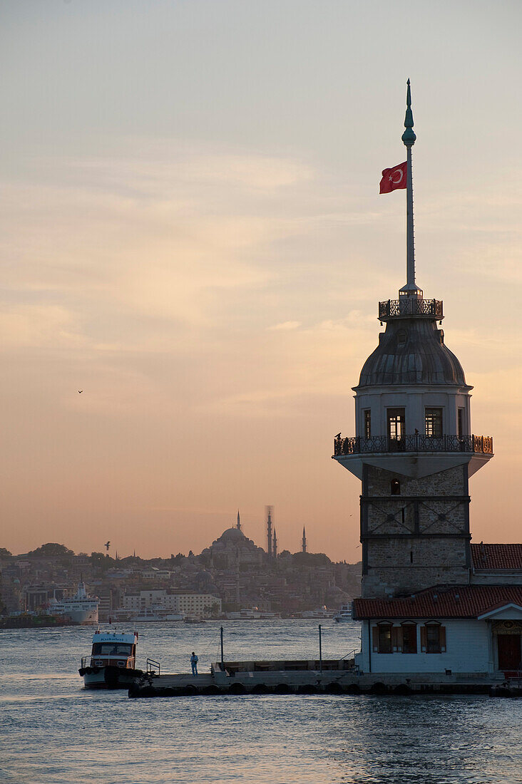 Leander's Tower at dusk with Suleymaniye Mosque behind, Istanbul, Turkey