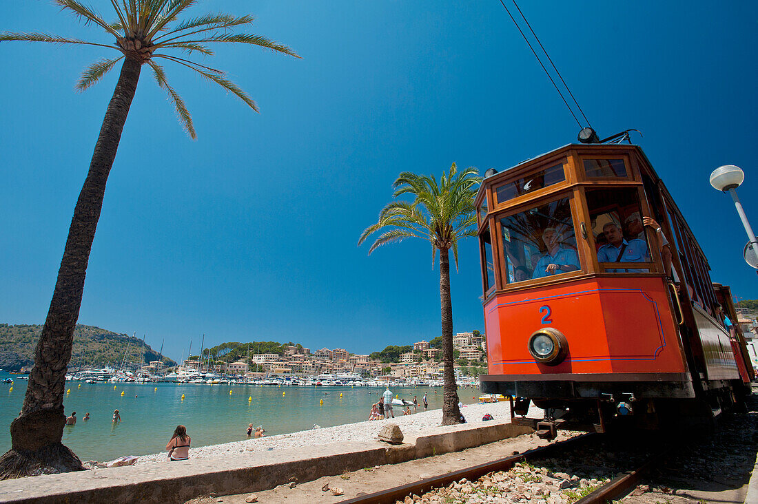 Port Soller to Soller tram going past beach of Port Soller, Majorca, Spain