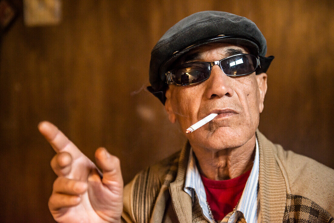 Man wearing sunglasses and smoking a cigarette, Amman, Jordan, Middle East