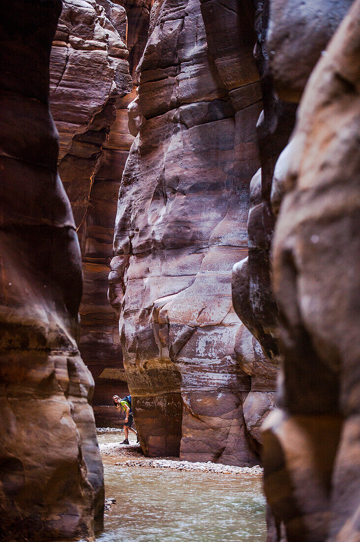 Woman hiking through a gorge, Wadi Mujib, Jordan, Middle East