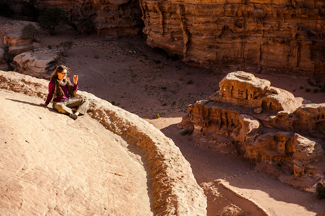 Woman on the roof of Ad Deir, Petra, Jordan, Middle East