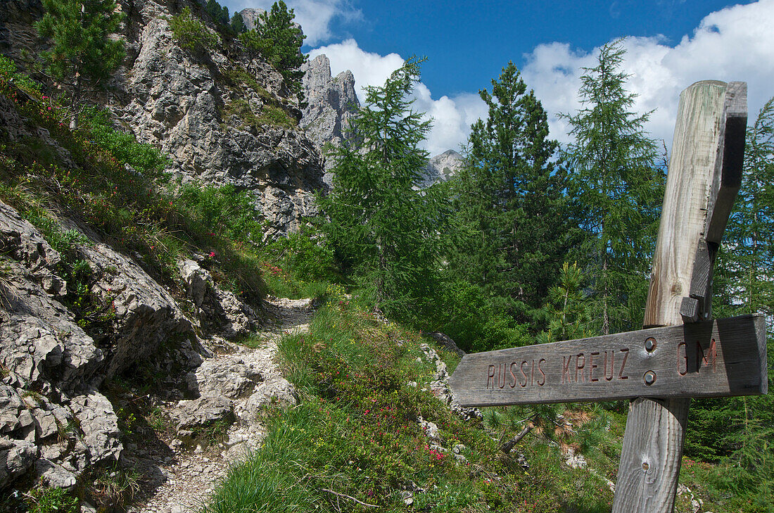 Wooden signpost on a walking trail to the Odle di Eores group, Val di Funes, Dolomiten Alps, South Tyrol, Upper Adige, Italy