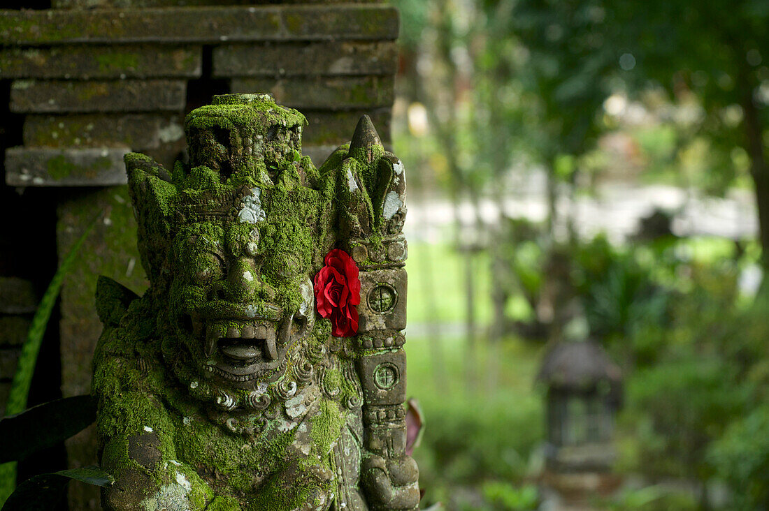 Temple guard figure at the entrance to Tirtha Empul temple at a sacred spring, East of Ubud, central Bali, Indonesia