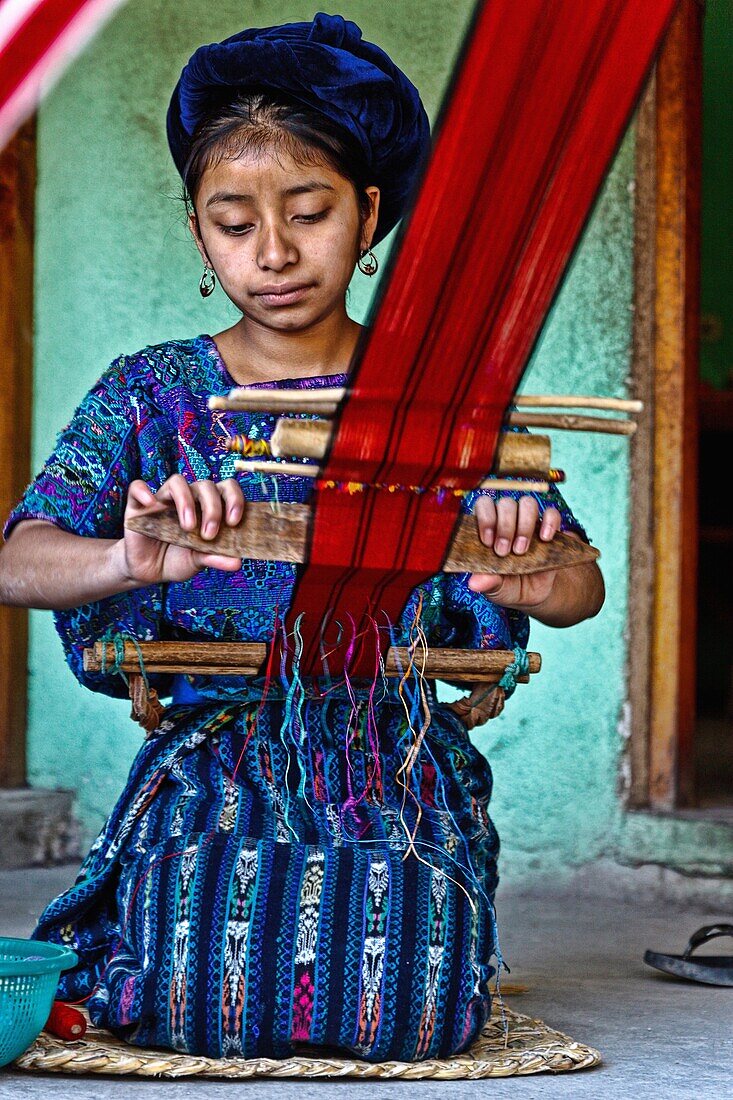 maya children weaving in santa catarina palopo in atitlan lake. guatemala