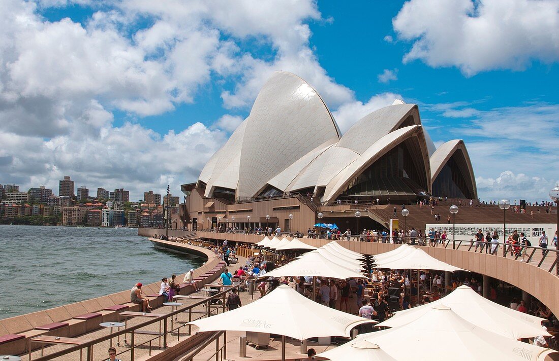 Restaurant and umbrellas in area of famous Sydney Opera House in harbour in New South Wales in Australia