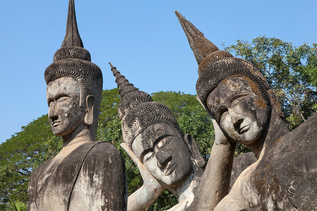 Three Buddhistic sculptures in Xieng Khuan Buddha Park in Vientiane, capital of Laos, Asia
