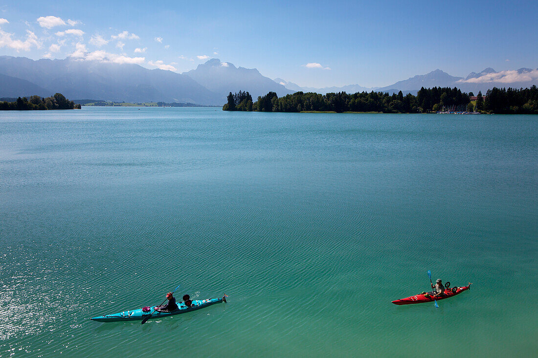 Canoes on lake Forggensee, Allgaeu Alps with Tegelberg, Saeuling and Tannheim mountains in the background, Allgaeu, Bavaria, Germany