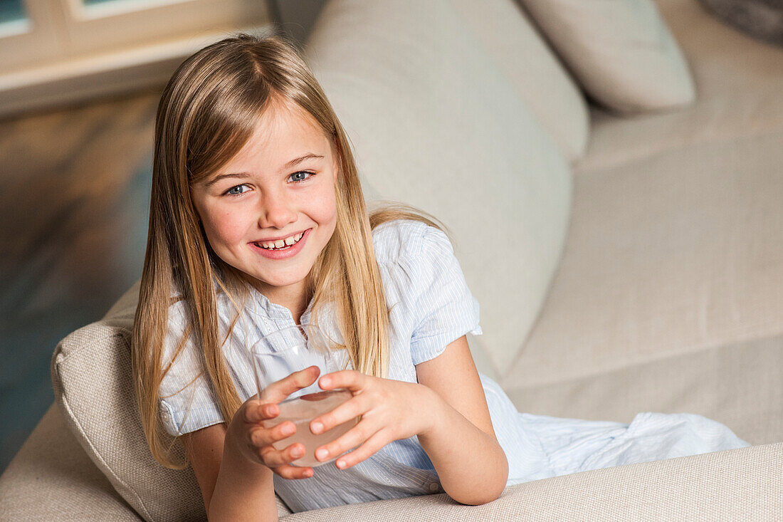 Girl holding a glass of water, Hamburg, Germany