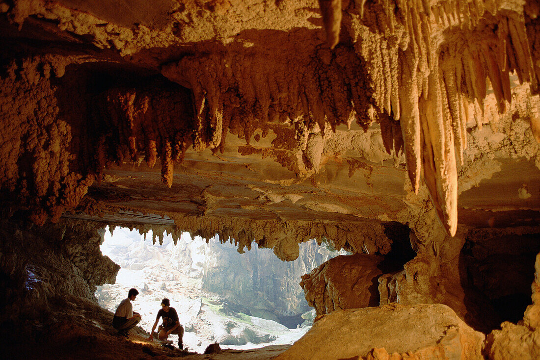 Visitors explore an expansive cavern with stalactites, Vale Do Peruacu, Minas Gerais, south Cerrado savannah, Brazil