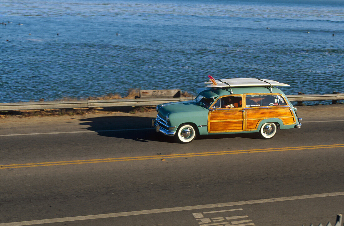 Pleasure Point surf check in a 1950 Ford Woodie owned by Jim Cocores, Santa Cruz, California