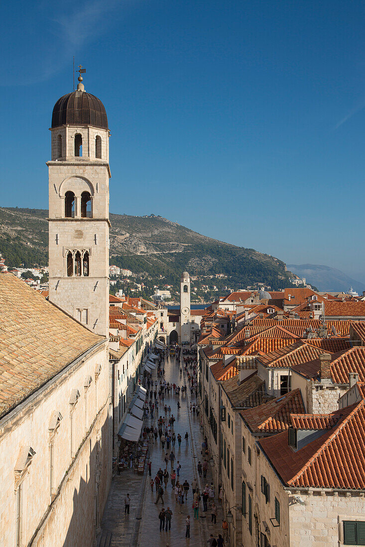 Pedestrians in the old town Placa with Franciscan Church monastery tower seen from the city wall, Dubrovnik, Dubrovnik-Neretva, Croatia