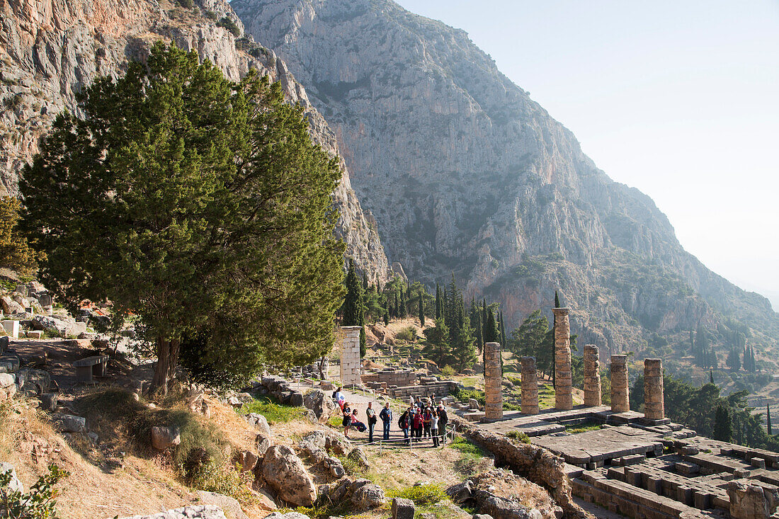 People admiring the 4th century B.C. Delphi ruins, Delphi, Peloponnese, Central Greece, Greece