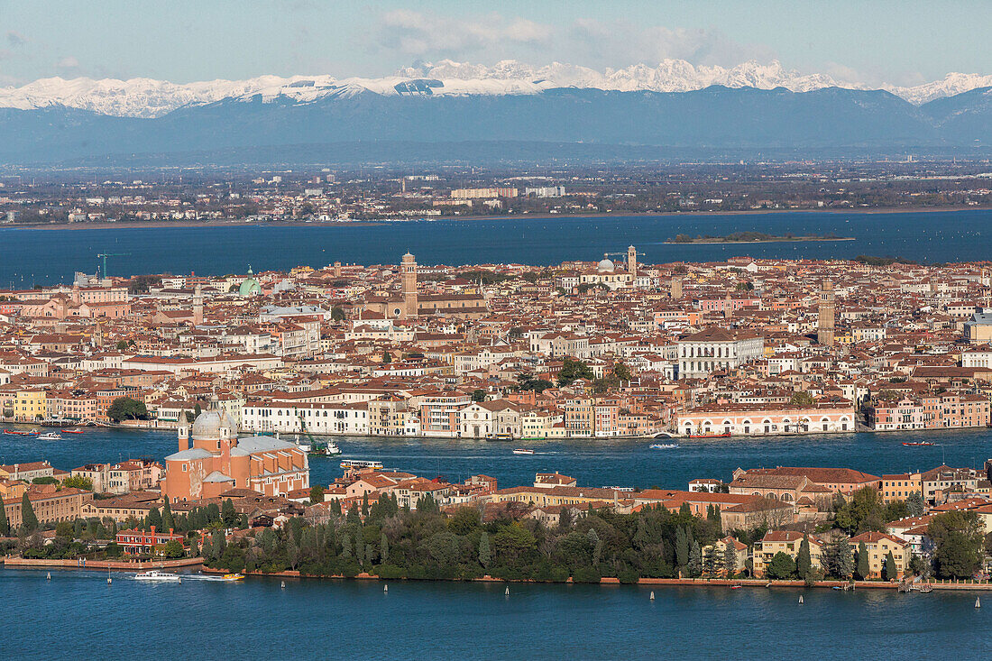 Aerial view of Venice with Giudecca, San Giorgio Maggiore and St Mark's Campanile, snow-capped mountains of the Alps in the background, Venice, Veneto, Italy