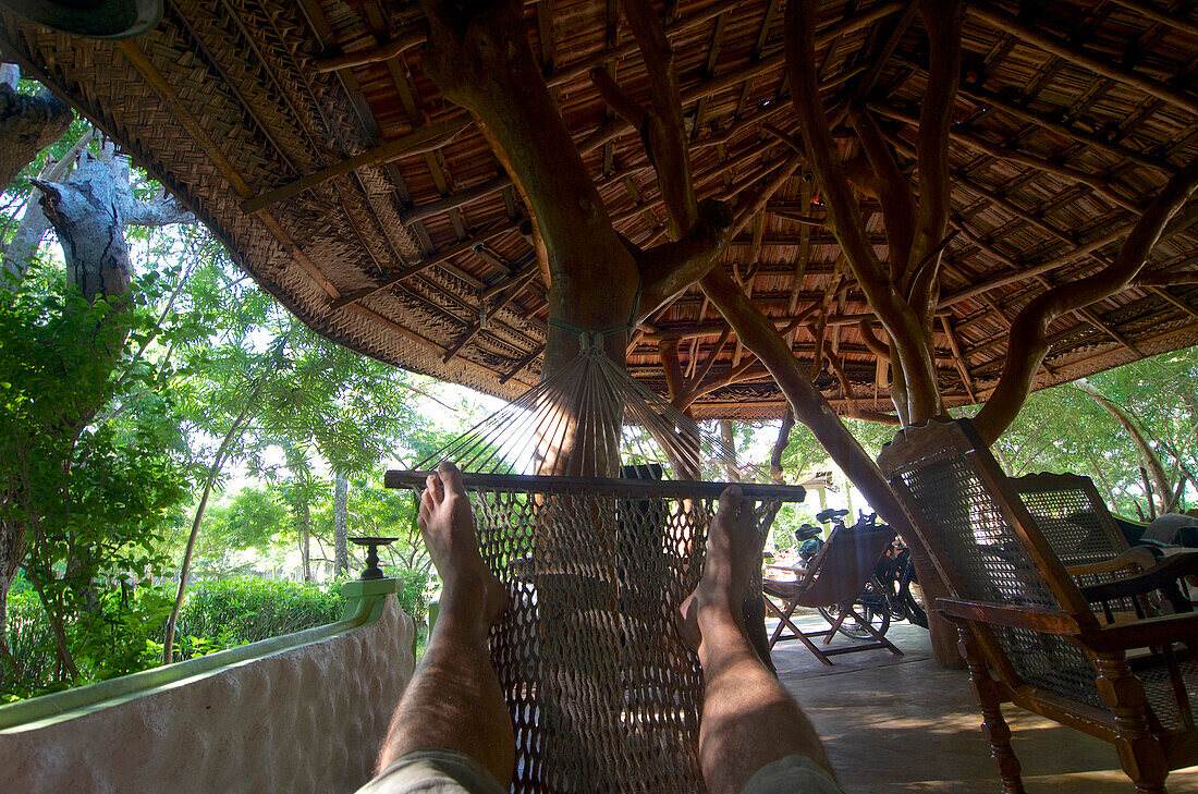 Resting in a hammock, view of feet, Beauties of Nature, small lodge next to Yala National Park, Kirinda in the South of Sri Lanka