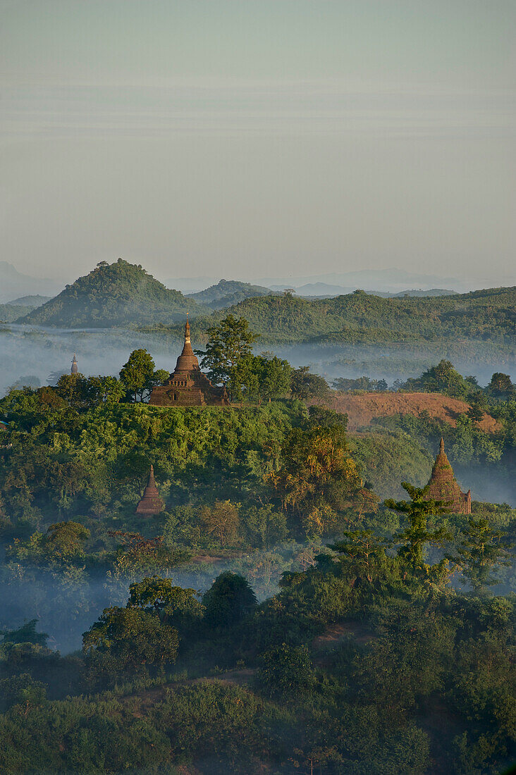 View above hill and pagodas in the morning mist at Mrauk U, Myohaung north of Sittwe, Akyab, Rakhaing State, Arakan, Myanmar, Burma