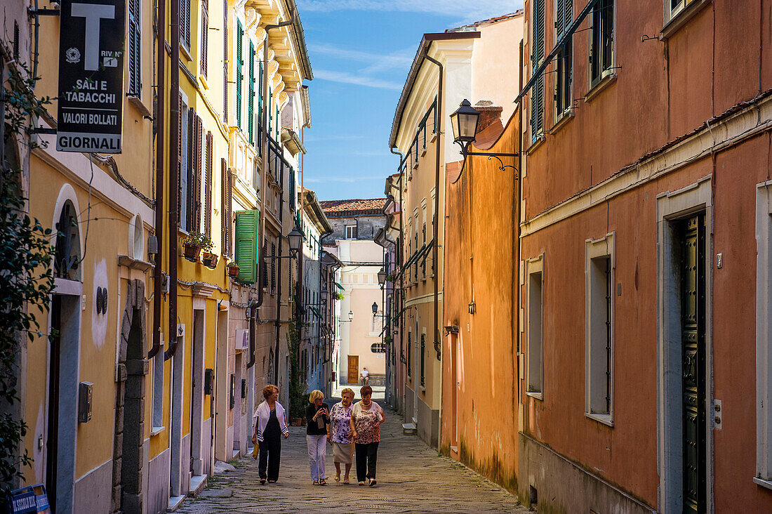 Four elderly women walking along a street in Castelnuovo Magra, province of La Spezia, Liguria, Italy